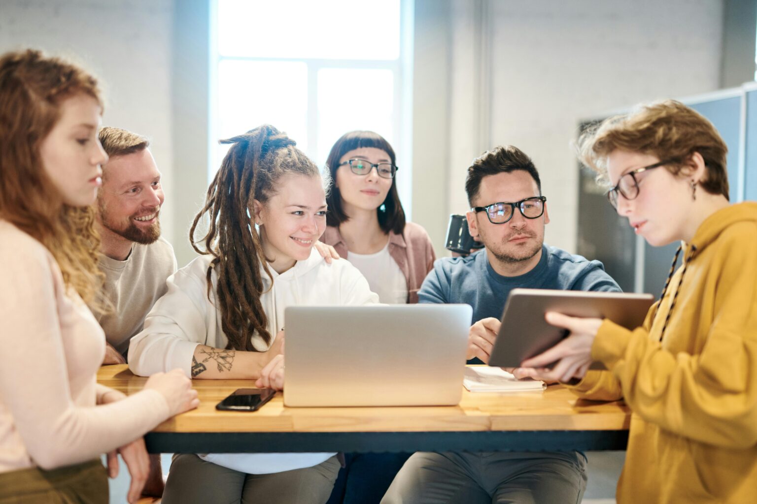 A creative team working jointly on writing a user-centric article utilizing UX principles.